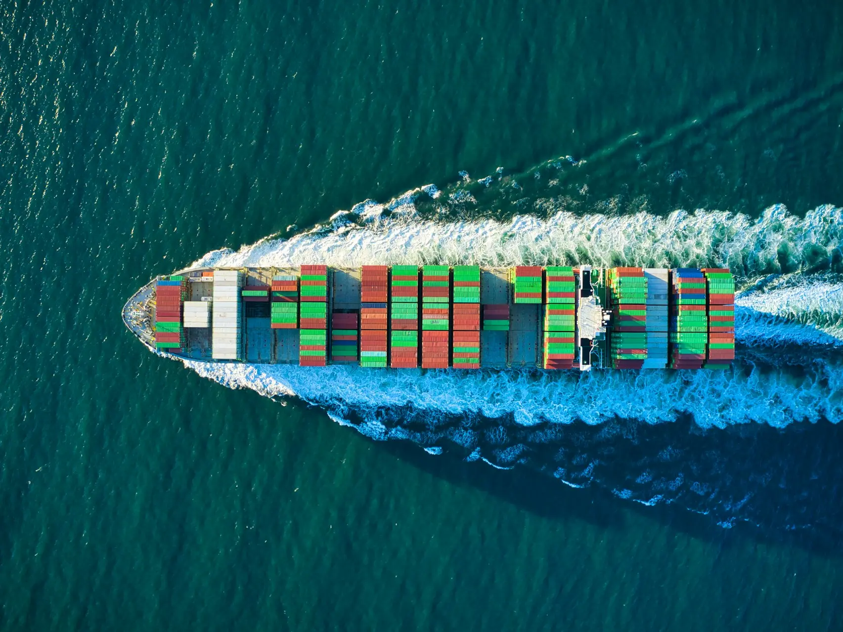 aerial view of blue and white boat on body of water during daytime